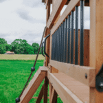 Sterling Point Wooden Swing Set With Covered Clubhouse, Slide, Belt Swings and Rock Wall - Image 6